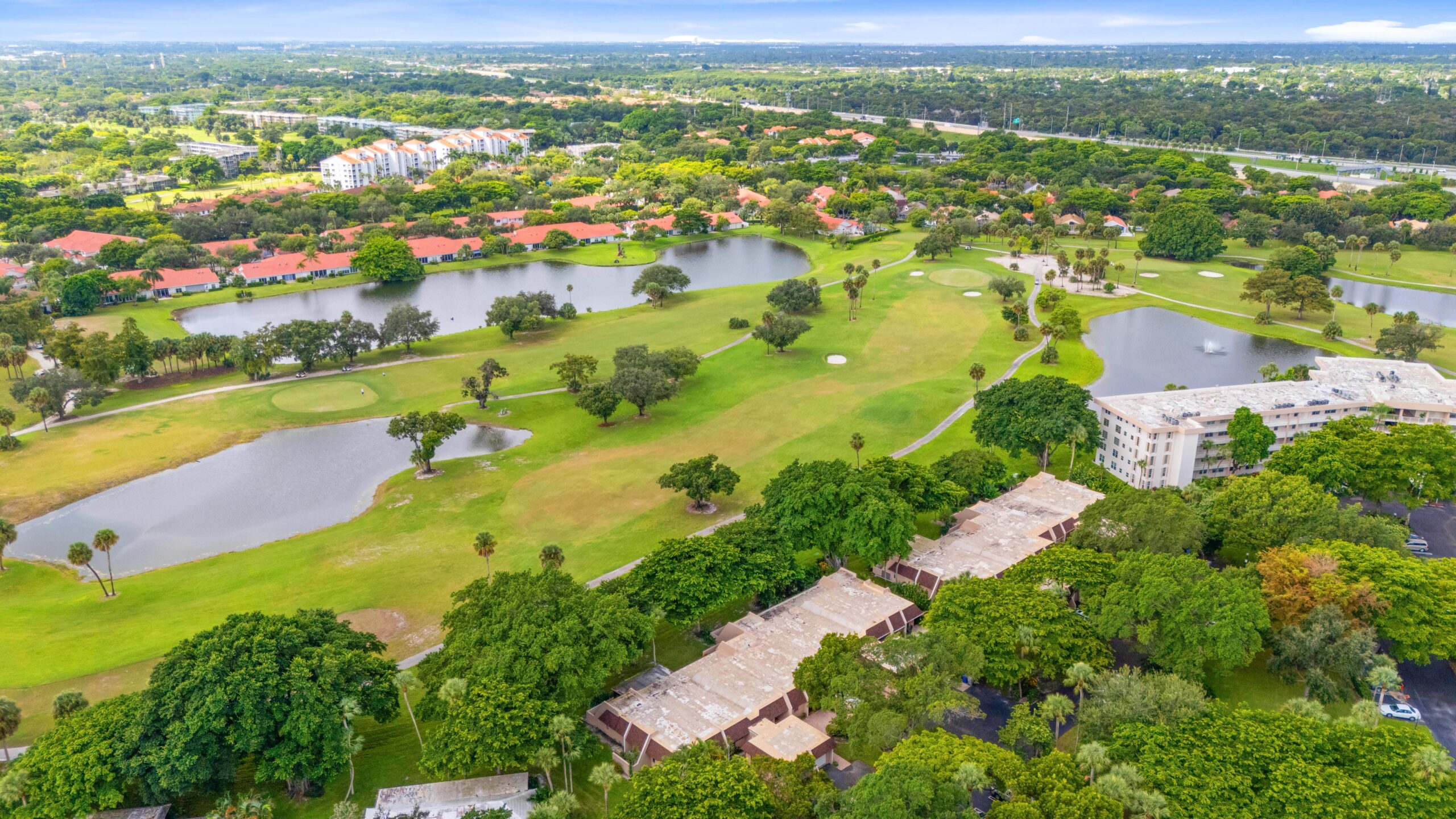 Aerial view of Palm Aire golf course community in Pompano Beach Florida with condos and water features