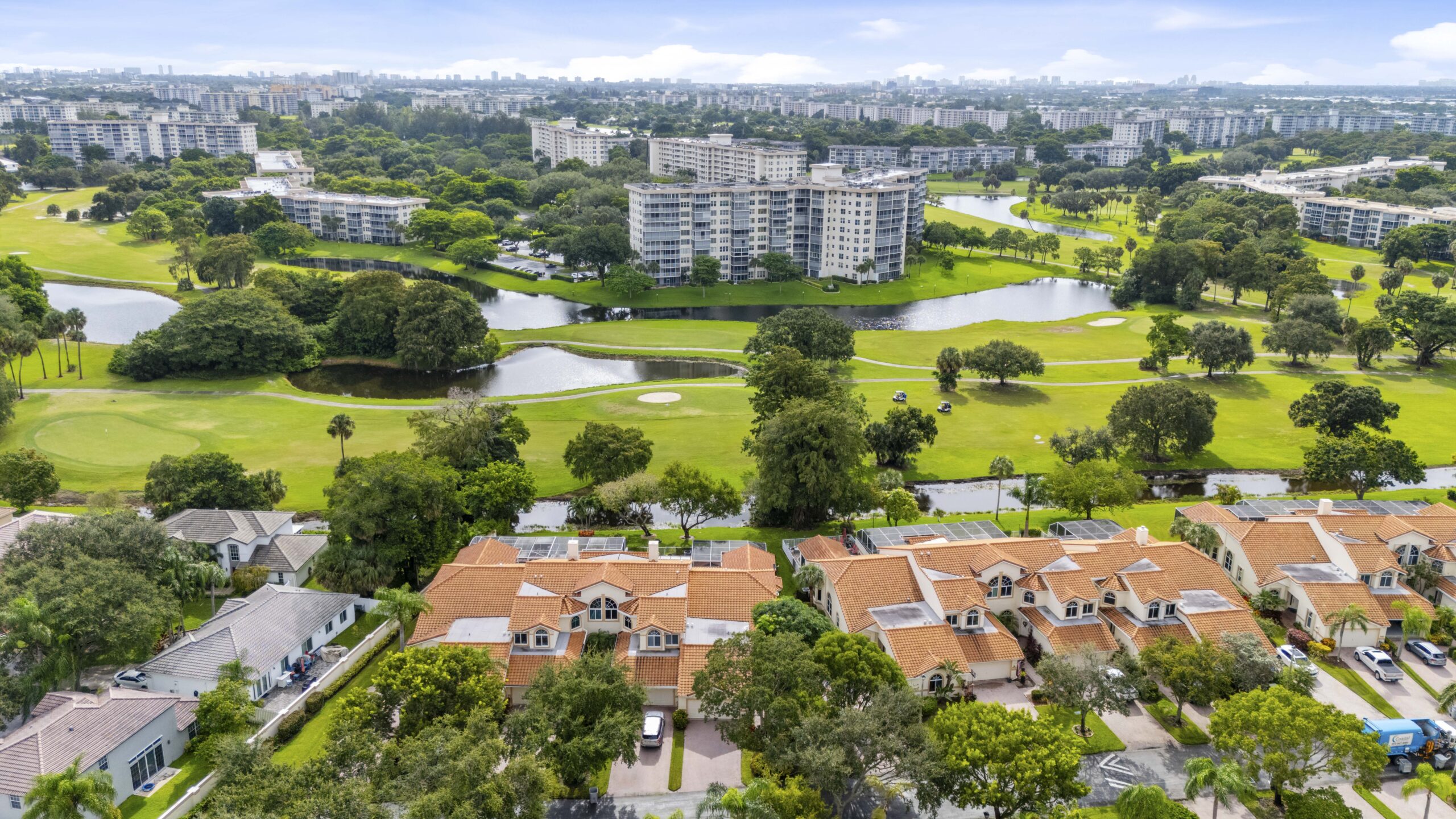 Aerial view of Palm Aire townhomes and golf course in Pompano Beach Florida with condos in background